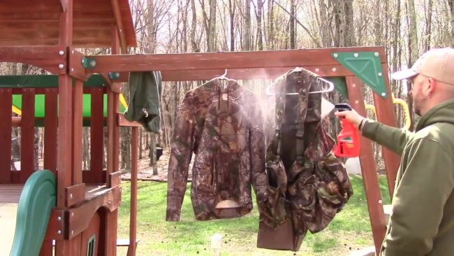 Spraying hunting clothes with Ben's